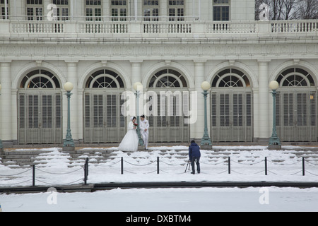 Marriage couple have photos taken at the Boat House in Prospect Park in winter. Brooklyn, NY. Stock Photo