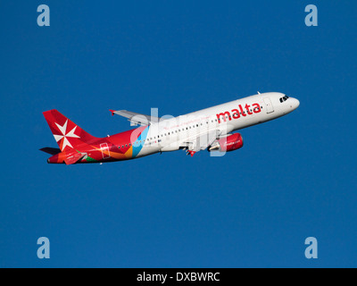 Air Malta Airbus A320 jet plane in flight on departure against a clear blue sky. Commercial flying and air travel. Stock Photo