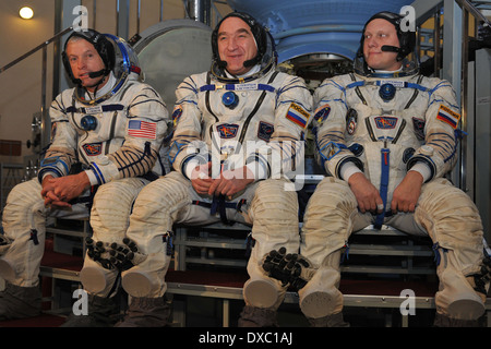 International Space Station expedition 39 crew members, left to right, Steve Swanson of NASA, Alexander Skvortsov of Roscosmos and Oleg Artemyev of Roscosmos in spacesuits talk to reporters at the Gagarin Cosmonaut Training Center March 5, 2014 in Star City, Russia. Launch of the crew is scheduled for March 26 for a six-month mission aboard the International Space Station. Stock Photo