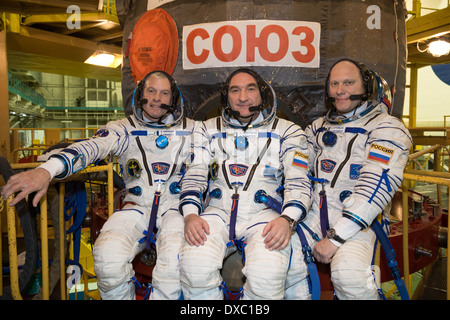 International Space Station expedition 39 crew members, left to right, Steve Swanson of NASA, Alexander Skvortsov of Roscosmos and Oleg Artemyev of Roscosmos in spacesuits at the Baikonur Cosmodrome March 14, 2014 in Baikonur Kazakhstan. Launch of the crew is scheduled for March 26 for a six-month mission aboard the International Space Station. Stock Photo