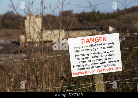 Danger sign at edge of working quarry, Lafarge Tarmac, Halecombe, Somerset, England, UK Stock Photo