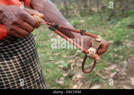 Tribal man using a Gulel (Slingshot) a hunting weapon. Santhal tribe. Bishangarh block, District Hazaribaug, Jharkhand Stock Photo