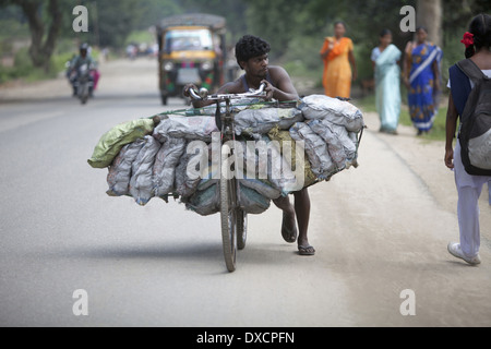 A tribal man carrying coals from village to town on bicycle. Munda tribe. Bariatu near Ranchi District Jharkhand, India Stock Photo