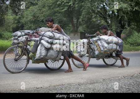 A tribal man carrying coals from village to town on bicycle. Munda tribe. Bariatu near Ranchi District Jharkhand, India Stock Photo