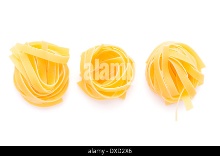 Food: dried italian pasta, fettuccine nests, isolated on white background Stock Photo