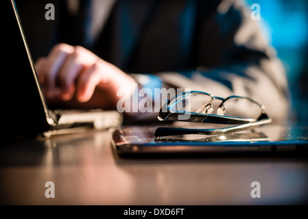 close up of hands typing on notebook in a table Stock Photo