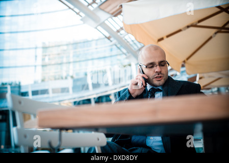 successful elegant fashionable businessman on the phone at the bar Stock Photo