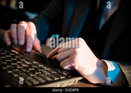 close up of hands typing on notebook in a table Stock Photo