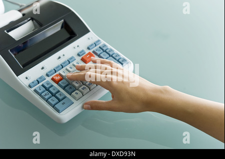 Closeup of woman's hand using calculator Stock Photo
