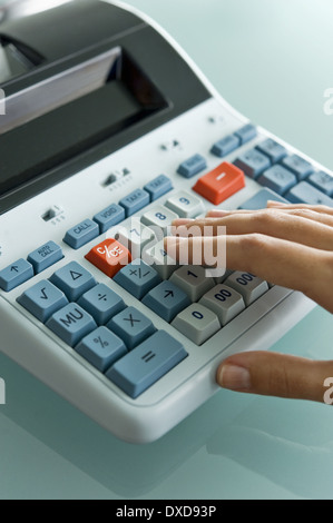 Closeup of woman's hand using calculator Stock Photo
