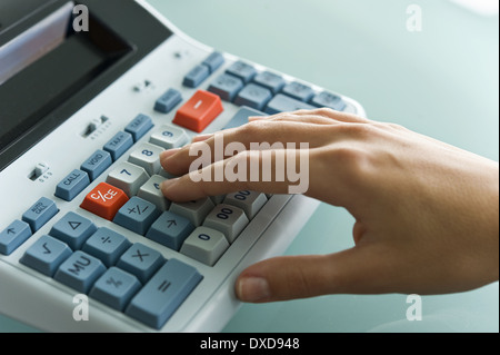 Closeup of woman's hand using calculator Stock Photo