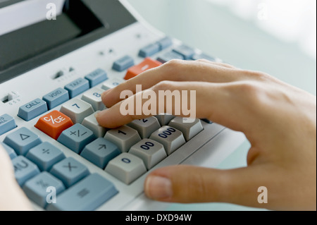Closeup of woman's hand using calculator Stock Photo