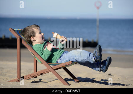Portobello Beach, Edingburgh, Scotland, UK . 24th Mar, 2014. Too Soon for a weather picture? This time last year motorists across the UK were digging their cars out of the snow with temperatures just above freezing.  Louis O'Brien, 2,  relaxes in his deckchair and enjoys an ice cream on Portobello Beach in Edinburgh with the temperature in Edinburgh at 10.2C and London 11.5C as Spring weather finally arrives. Credit:  pictureditor/Alamy Live News Stock Photo
