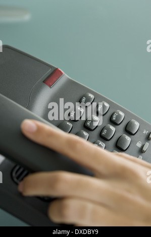 Closeup of woman's hand on telephone Stock Photo
