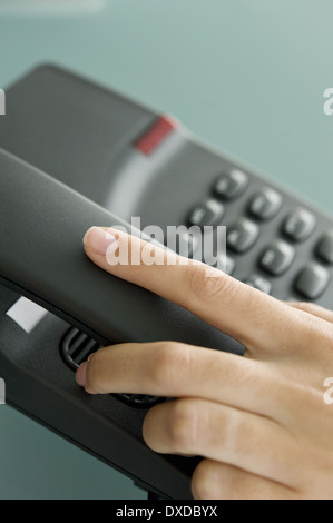 Closeup of woman's hand on telephone Stock Photo