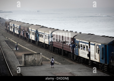 Passenger train at Bambalapitiya railway station on the waterfront of Colombo, Sri Lanka Stock Photo