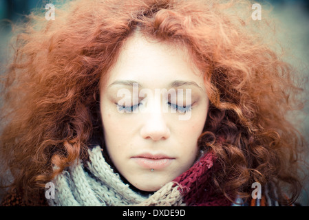 young beautiful red curly hair woman at the park Stock Photo