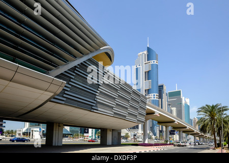 Daytime skyline view along skyscrapers and metro station and bridge on Sheikh Zayed Road in Dubai United Arab Emirates Stock Photo