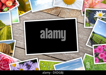 Stack of printed pictures collage on wooden table with copy space for your photo Stock Photo
