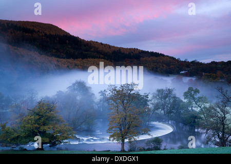 Autumn colours and mist in the Dee Valley (Dyffryn Dyfrdwy) at Horseshoe Falls near Llangollen, Denbighshire, Wales Stock Photo