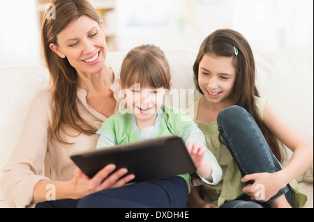 Mother and daughters (4-5,8-9) using tablet pc Stock Photo
