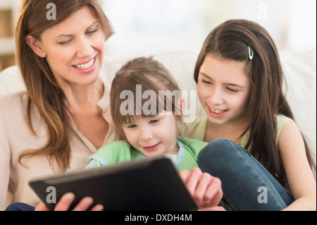 Mother and daughters (4-5,8-9) using tablet pc Stock Photo