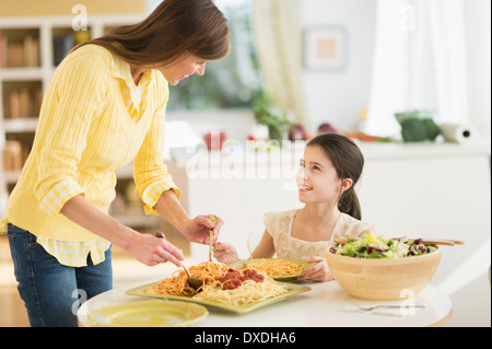 Mother and daughter (8-9) eating pasta Stock Photo