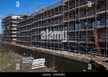 Manchester, UK.  24th March, 2014. Islington Wharf Mews grows, ISIS Waterside Regeneration — a joint venture between Muse Developments and the Canal & River Trust — is developing a residential scheme on the Ashton Canal, part of the New Islington, New East Manchester area. The first, award-winning phase of the scheme was completed in 2008 and is now fully occupied.  ISIS received planning permission for the second phase of development, Islington Wharf Mews, in November 2012 and construction has now commenced. Stock Photo