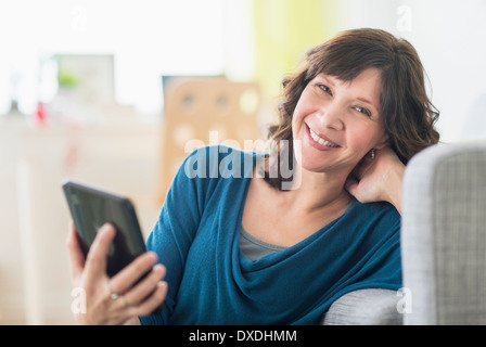 Portrait of woman holding tablet pc Stock Photo