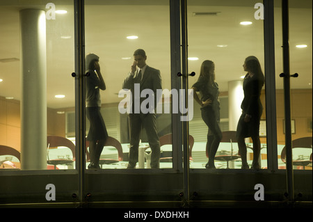 Businessmen and businesswomen in office building Stock Photo