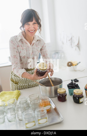 Woman making preserves in kitchen Stock Photo