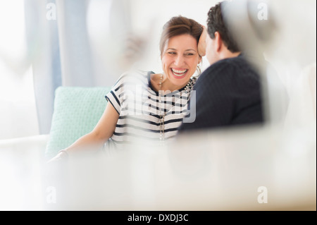 Couple sitting on sofa Stock Photo