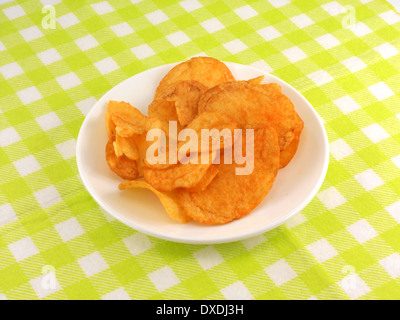 Potato chips falling in the white plate Stock Photo
