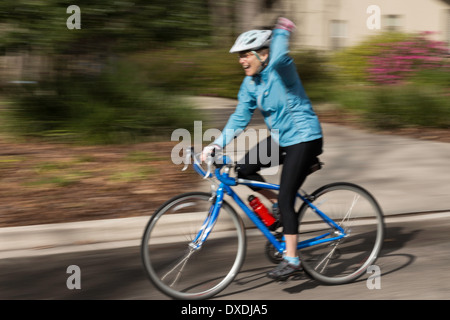 Female Cyclist Celebrates Her Finish, USA Stock Photo