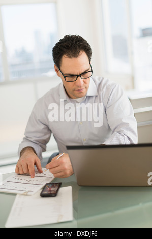 Businessman using laptop and digital tablet Stock Photo