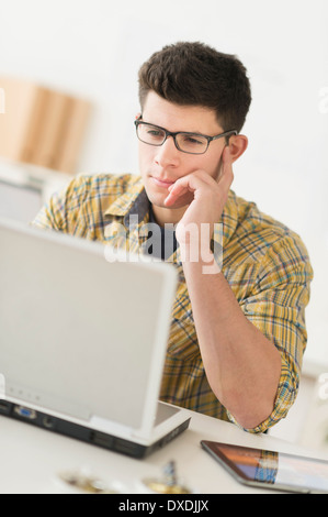 Young man using computer Stock Photo