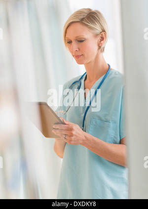 Female nurse using tablet PC Stock Photo