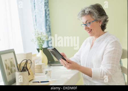 Mature woman using tablet PC Stock Photo