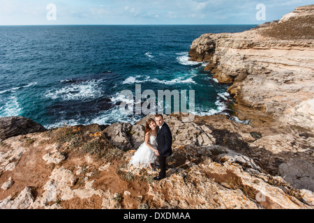 Bride and groom near the ocean Stock Photo