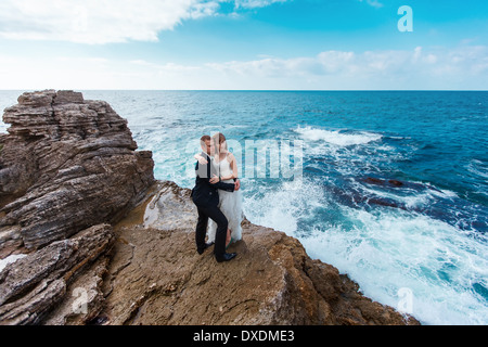 Bride and groom near the ocean Stock Photo