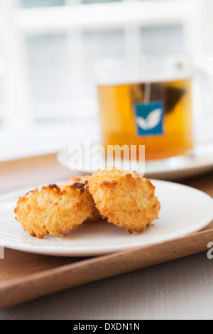 Coconut Macaroons with Cup of Tea in background, Studio Shot Stock Photo