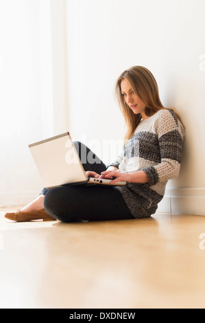 Portrait of young woman using laptop Stock Photo