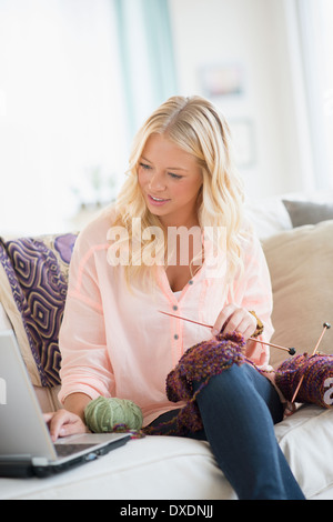 Portrait of young woman learning knitting Stock Photo