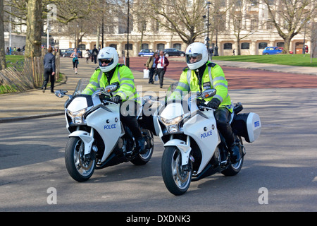 Two high visibility Metropolitan Police officers motorbike riders on Honda motorcycles patrolling Horse Guards Parade in central London England UK Stock Photo