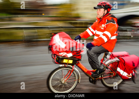 Postman on delivery bike in York Yorkshire Stock Photo