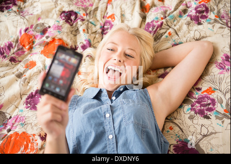 Portrait of young woman using mobile phone Stock Photo