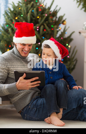 Father and son (6-7) using tablet Stock Photo