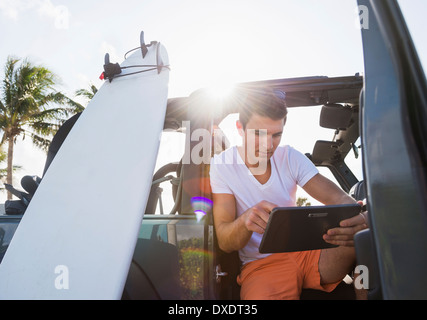 Young man using digital tablet, Jupiter, Florida, USA Stock Photo