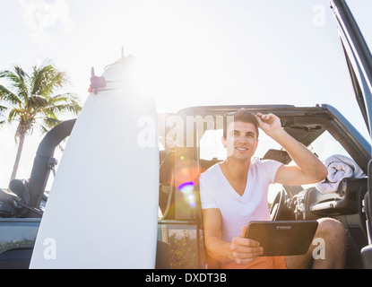 Young man using digital tablet, Jupiter, Florida, USA Stock Photo