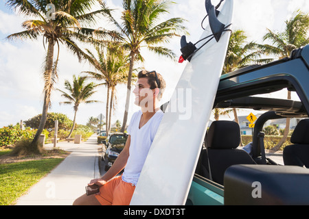 Young man holding mobile phone, Jupiter, Florida, USA Stock Photo